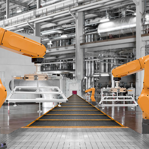 slika prikazuje fotografija industrijske opreme: v ospredju rumene kovinske cevi z več spojkami, manometri in vijaki; nekaj ventilov ter merilnikov so jasno vidni, oprema je urejena in tehnična, ozadje je neostro, osredotočeno na natančno in robustno industrijsko izvedbo.