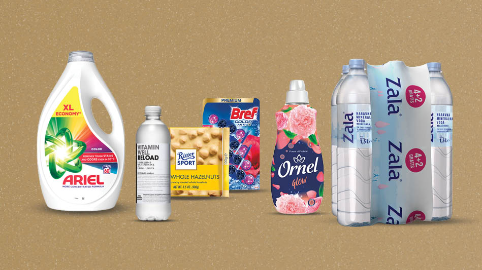Izdelki na svetlo rjavo-zlatem ozadju: Tekoči detergent Ariel Color, Vitamin Well voda, Čokolada Ritter sport, bela čokolada s celimi lešniki, 100 g, WC-obešanka Bref CA Flower, 4 x 50 g, Mehčalec Ornel Glow, 1,6 L   in 6kosov voda Zala 1,5 L.