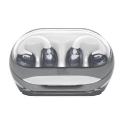 Polnilna škatlica JBL s prosojnim pokrovom in shranjenimi slušalkami.