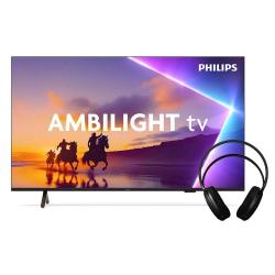 Philips Ambilight TV: velik zaslon s prizorom jahanja na plaži ob sončnem zahodu, priložene črne slušalke