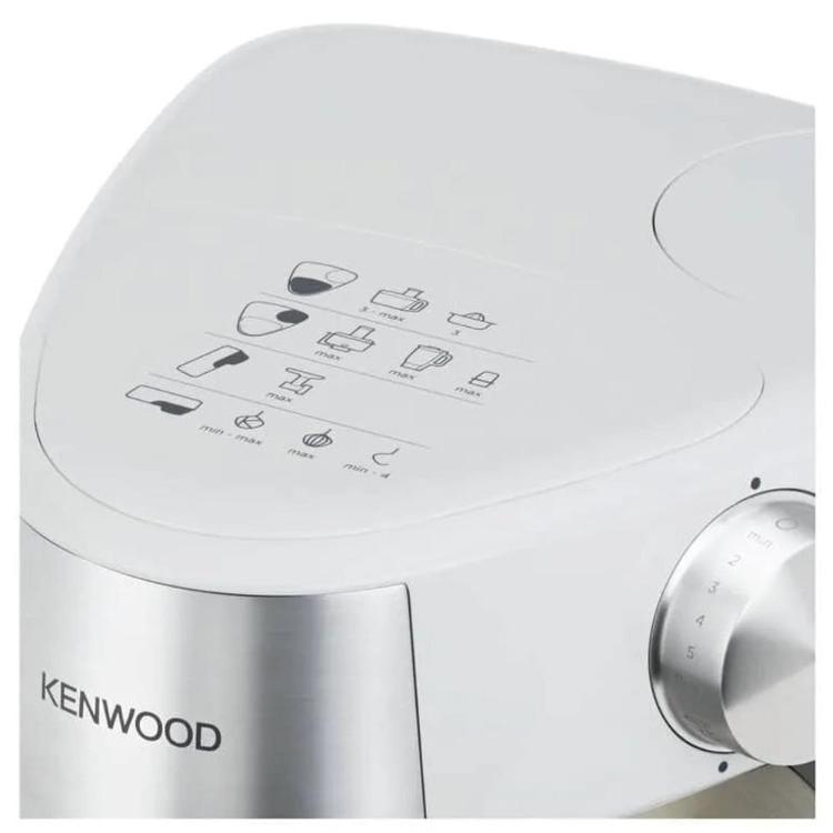 Kenwood kuhinjski robot v beli barvi, prikazan z vrtljivim gumbom za nastavitev hitrosti in prikazom priporočenih nastavkov na zgornjem delu ohišja.