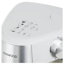 Kenwood kuhinjski robot v beli barvi, prikazan z vrtljivim gumbom za nastavitev hitrosti in prikazom priporočenih nastavkov na zgornjem delu ohišja.