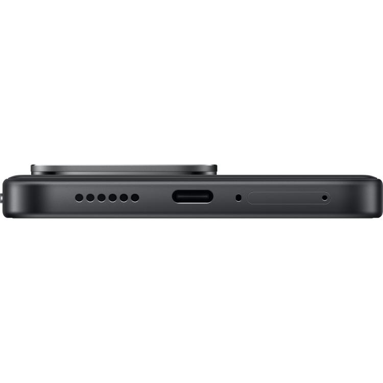 Spodnji rob črnega pametnega telefona Redmi 5G z vhodom USB-C, zvočnikom, mikrofonom in režo za kartico SIM.